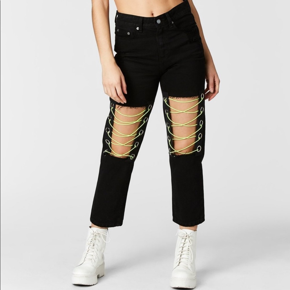 Denim jeans with bungee string across the knees